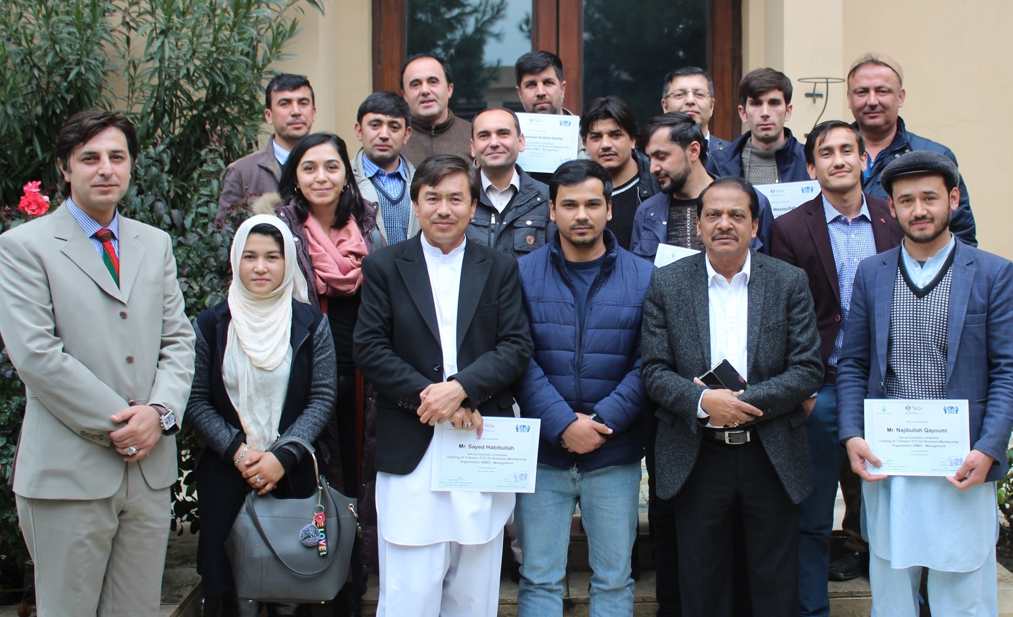 A project has been completed and people are standing holding their certificates, aicb, afghan innovative consulting bureau, consultancy, advisor, consultant, consultancy in Afghanistan, best consultancy